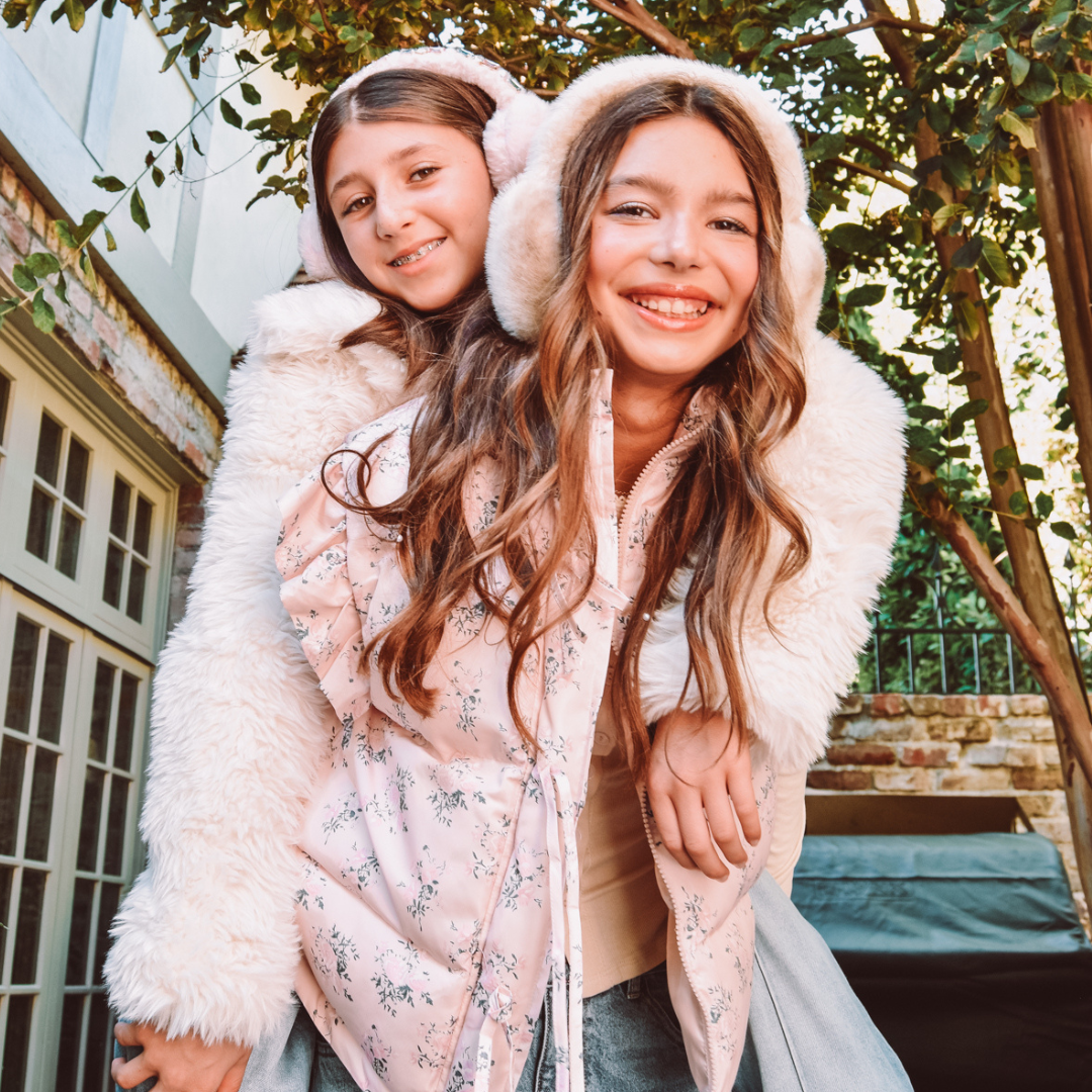 Two girls bundled for cold weather.