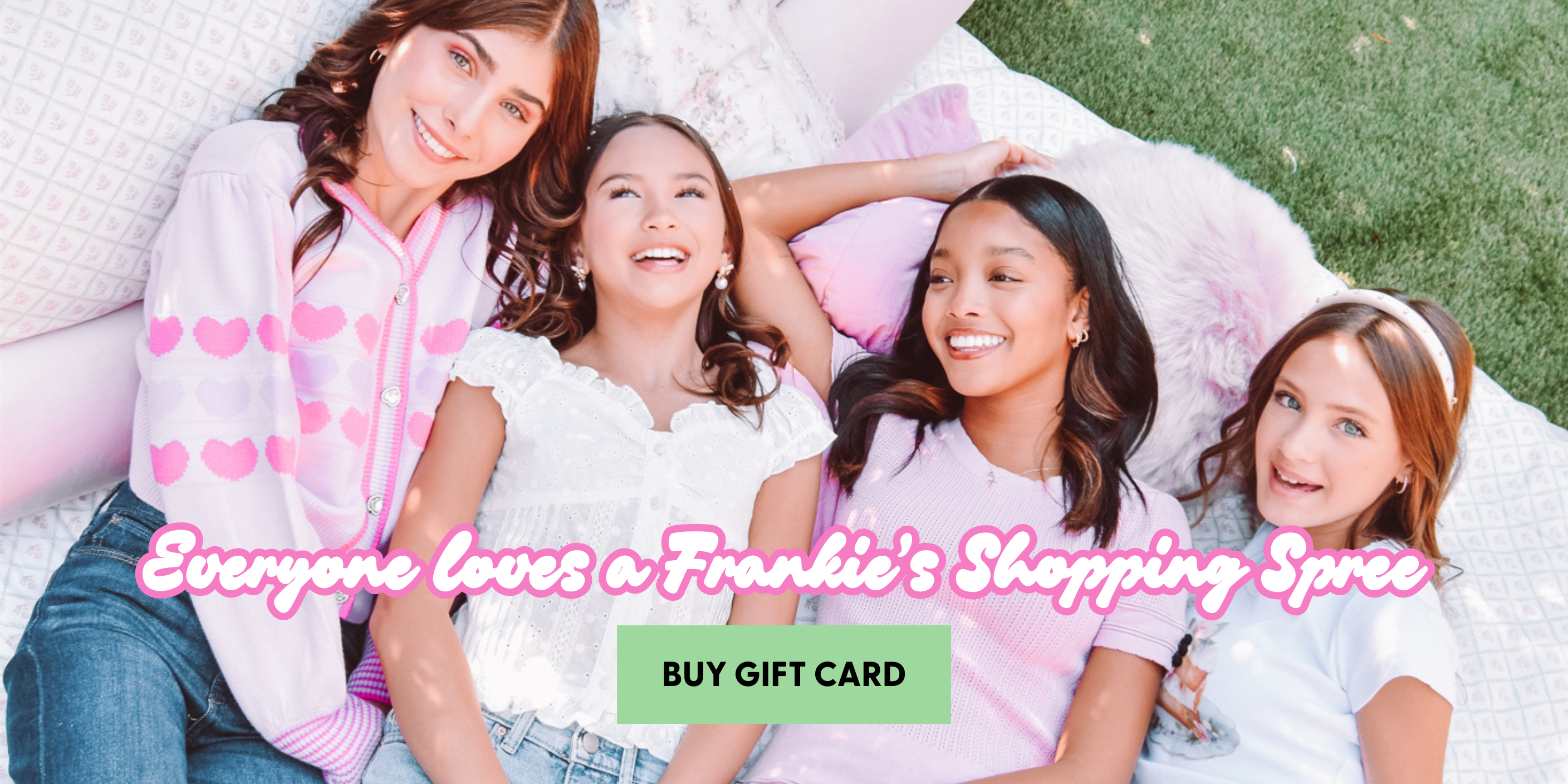 Four young girls lying on a blanket outdoors with promotional text overlay.